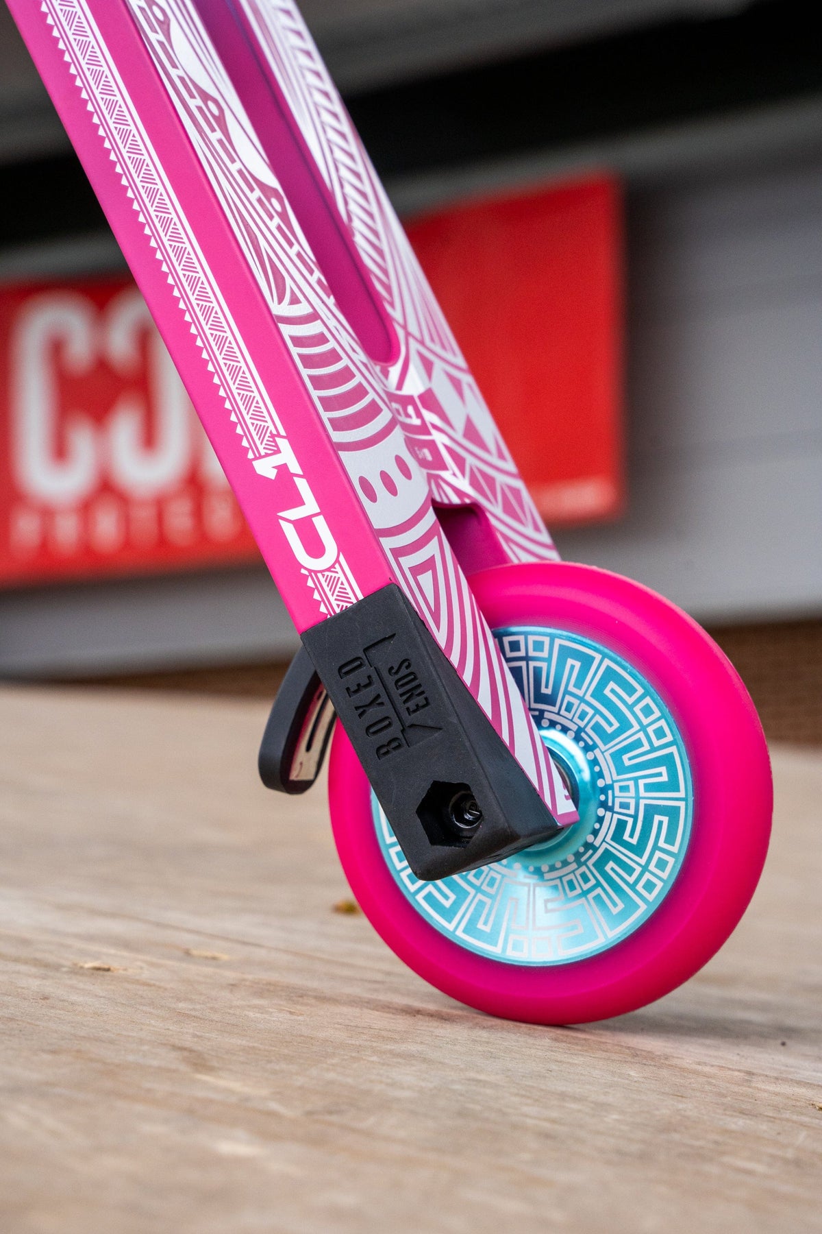 CORE CL1 complete stunt scooter in pink and teal - at skatepark