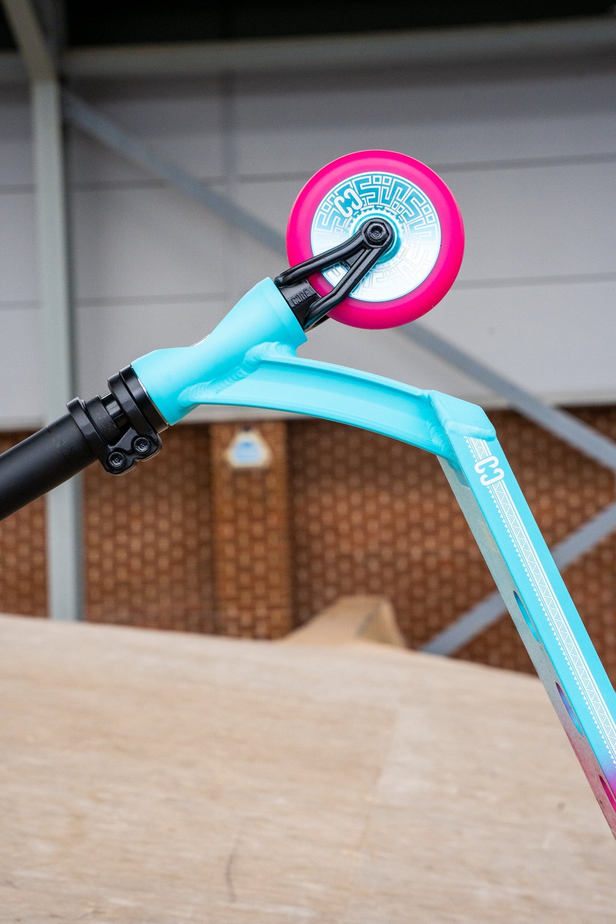 CORE CL1 complete stunt scooter in pink and teal - front wheel underside